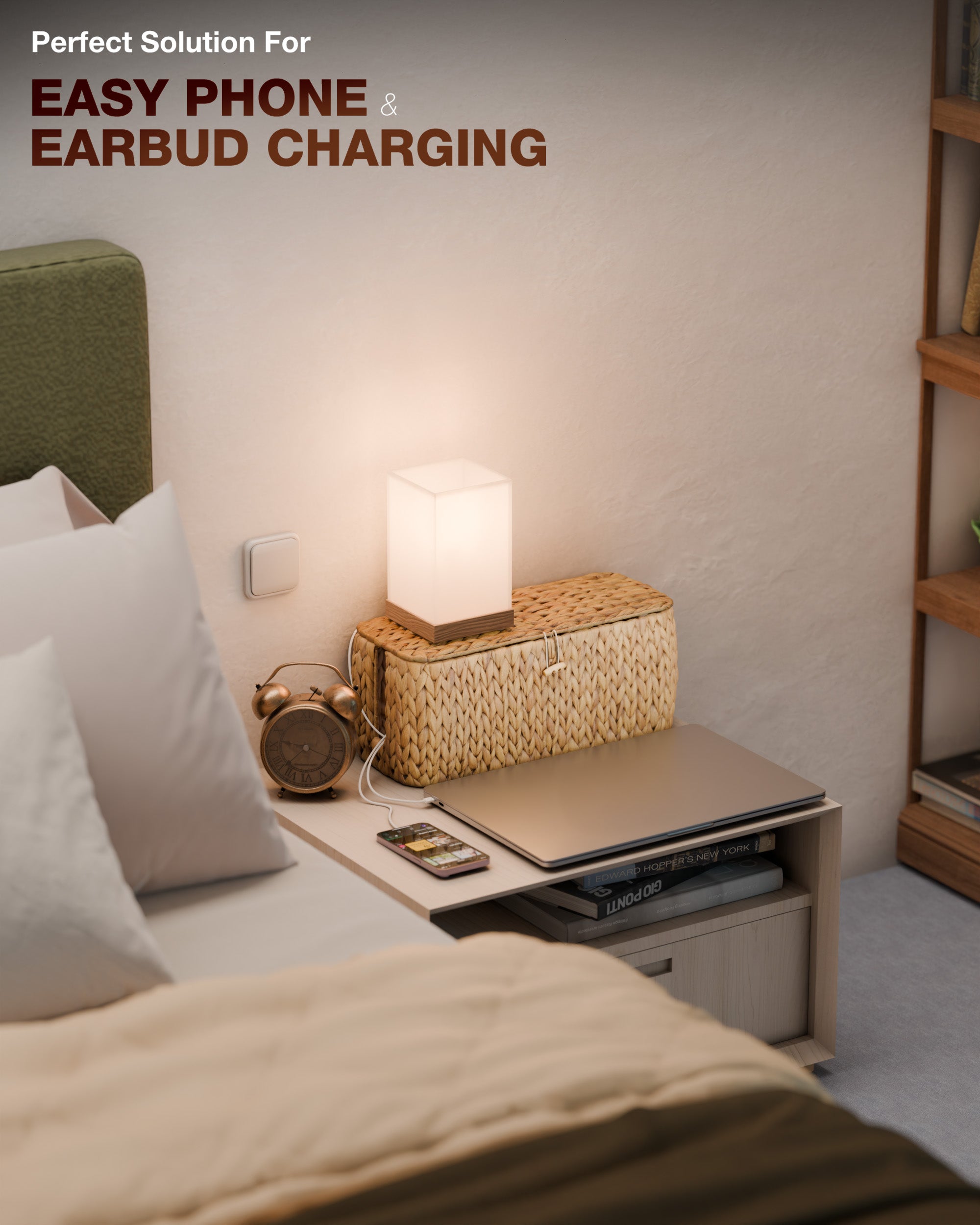 Bedside table with phone, earbuds, and lamp in a bedroom setting.