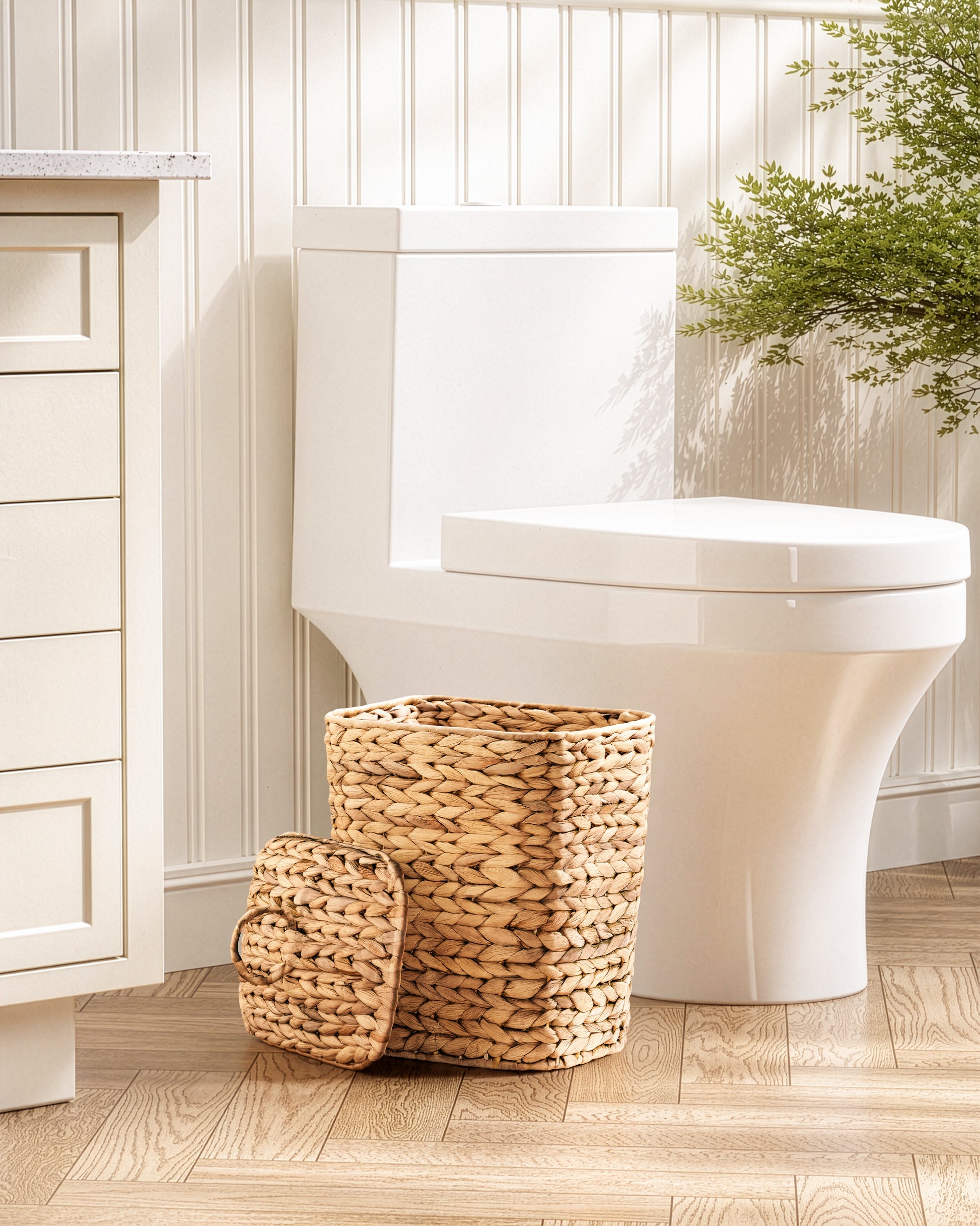 White toilet with woven basket on a wooden floor in a bathroom setting