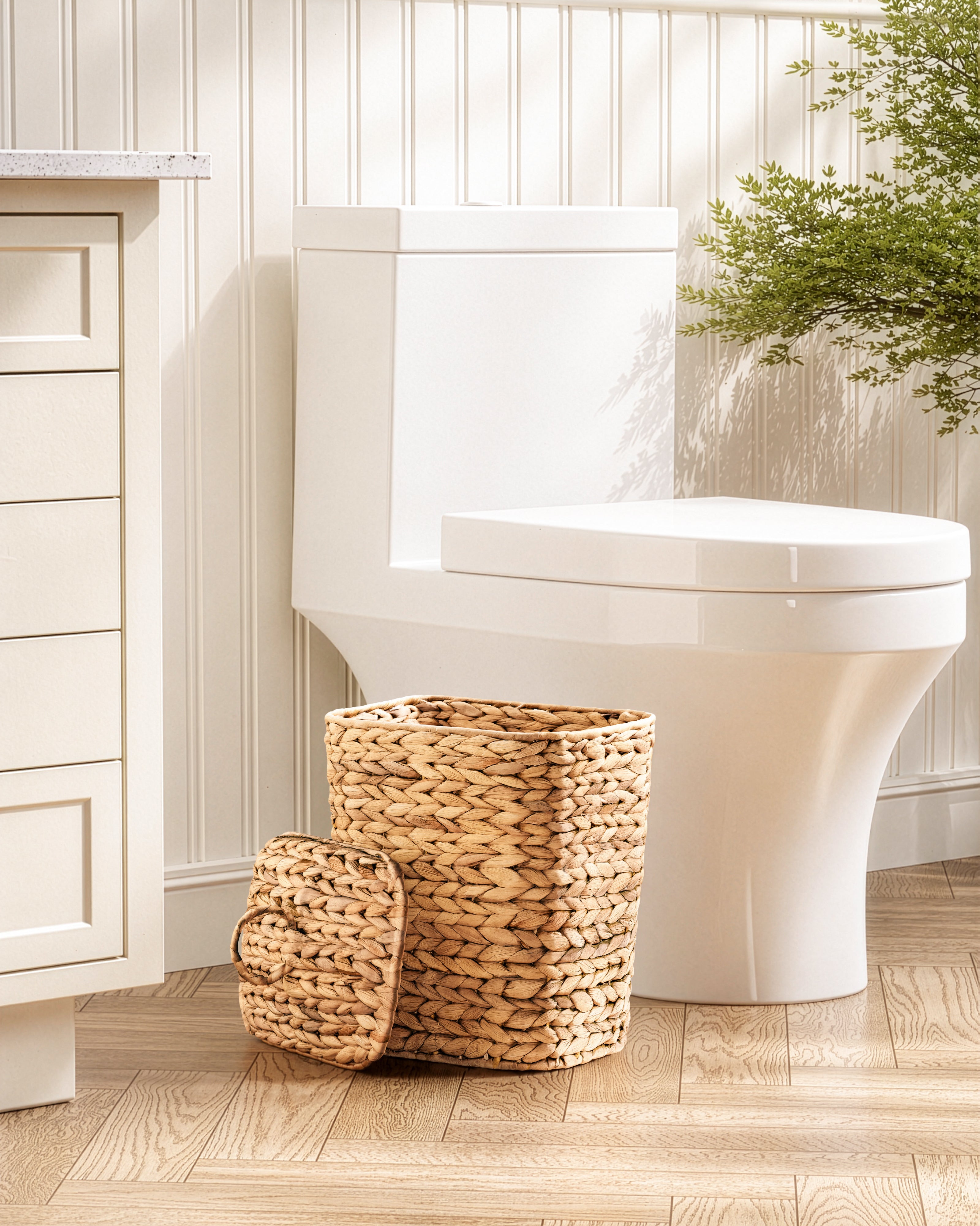 White toilet with woven basket on a wooden floor in a bathroom setting