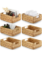 Set of six woven storage baskets with various items on a white background