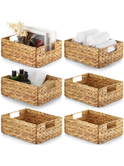Set of six woven storage baskets with various items on a white background