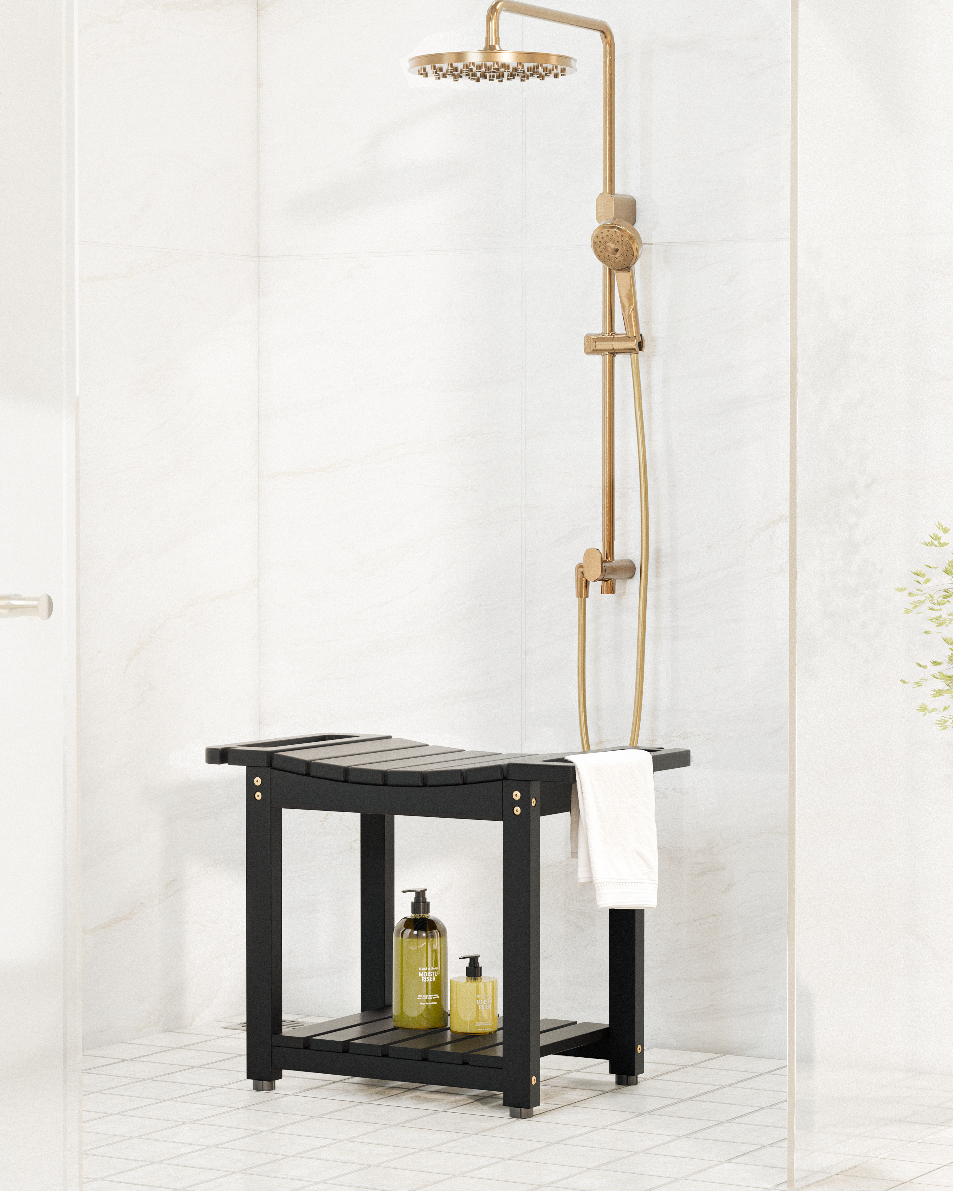 A modern shower setup featuring a black wooden bench with a lower shelf, a brass shower head and handheld hose, and a white towel, set against a white marble-tiled bathroom wall.