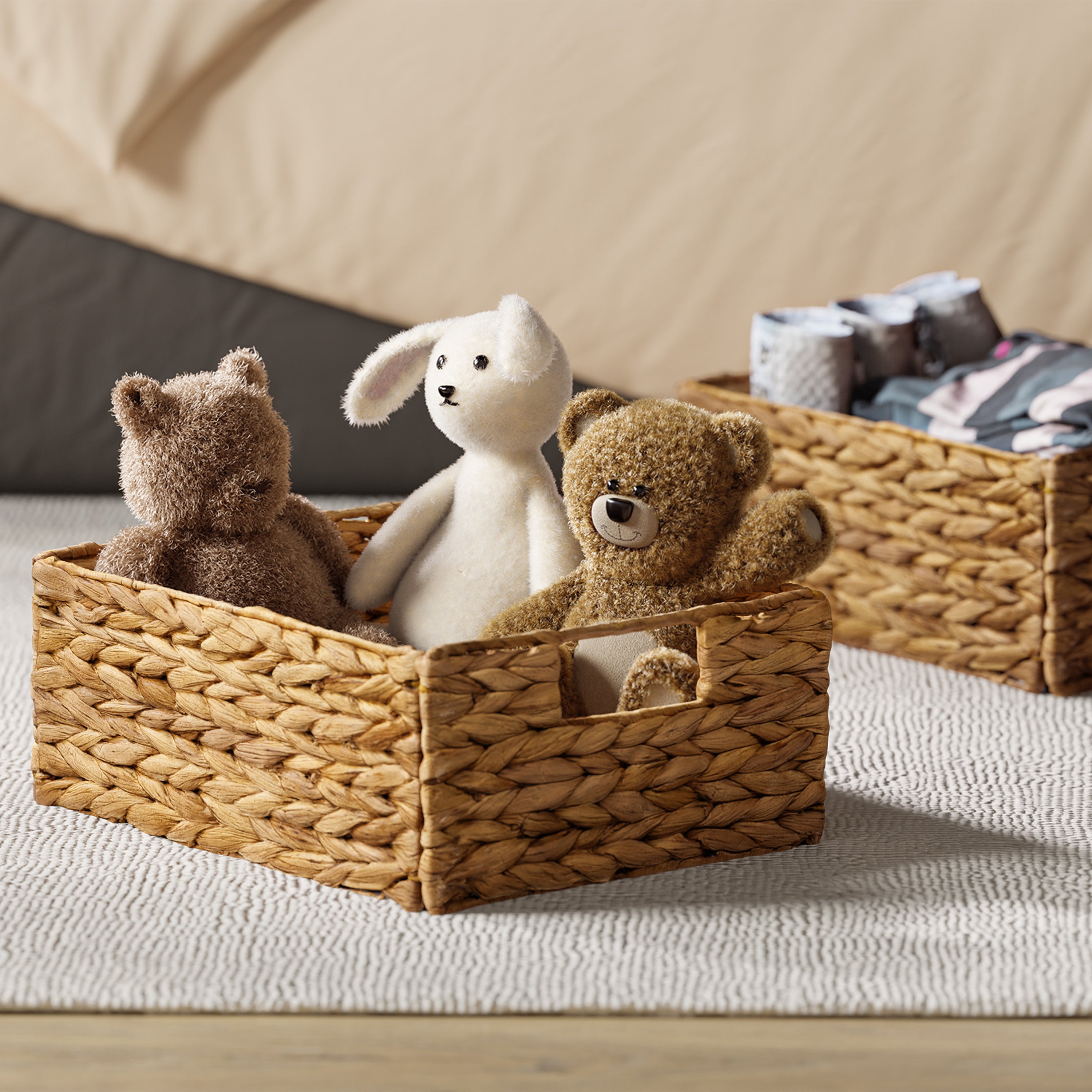 Woven basket with stuffed animals on a bed