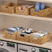 Woven baskets on a shelf with laundry items in a laundry room.