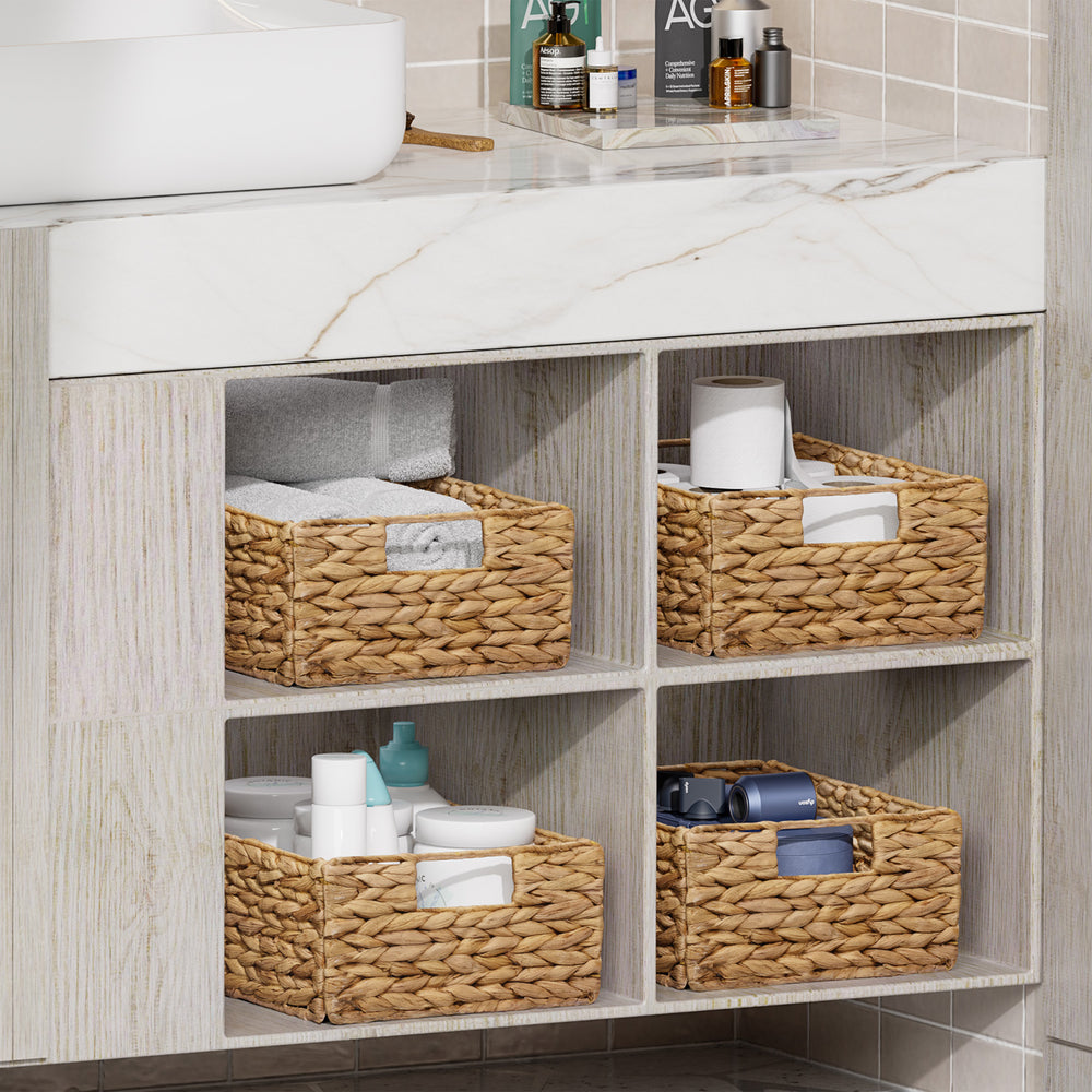 Bathroom vanity with woven baskets containing toiletries
