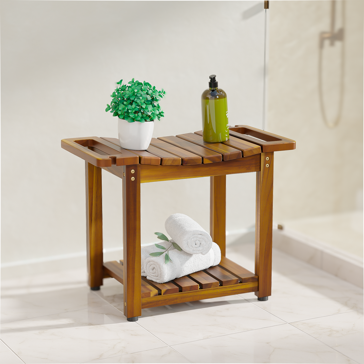 A wooden bathroom bench with a slatted top and lower shelf, styled with a small green potted plant, a green bottle, and white rolled towels, set in a bright bathroom.