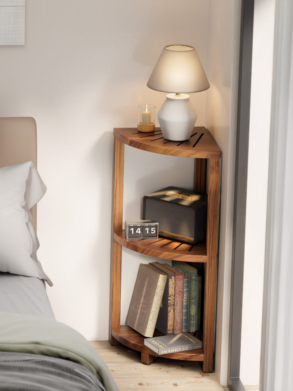 Wooden nightstand with books and a lamp next to a bed in a bedroom.
