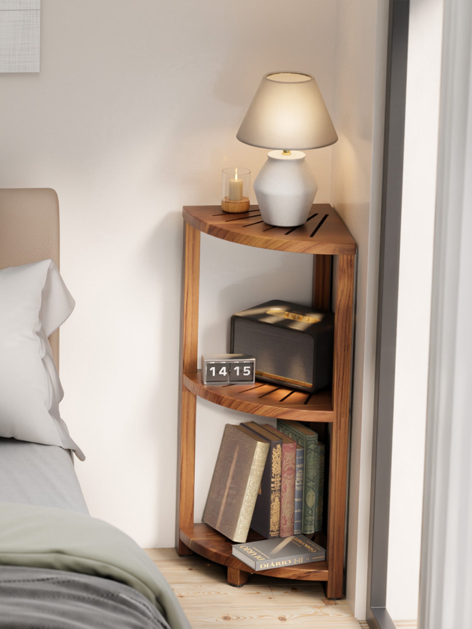 Wooden nightstand with books and a lamp next to a bed in a bedroom.