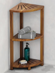 Wooden corner shower caddy with towels and soap on a gray tiled floor.