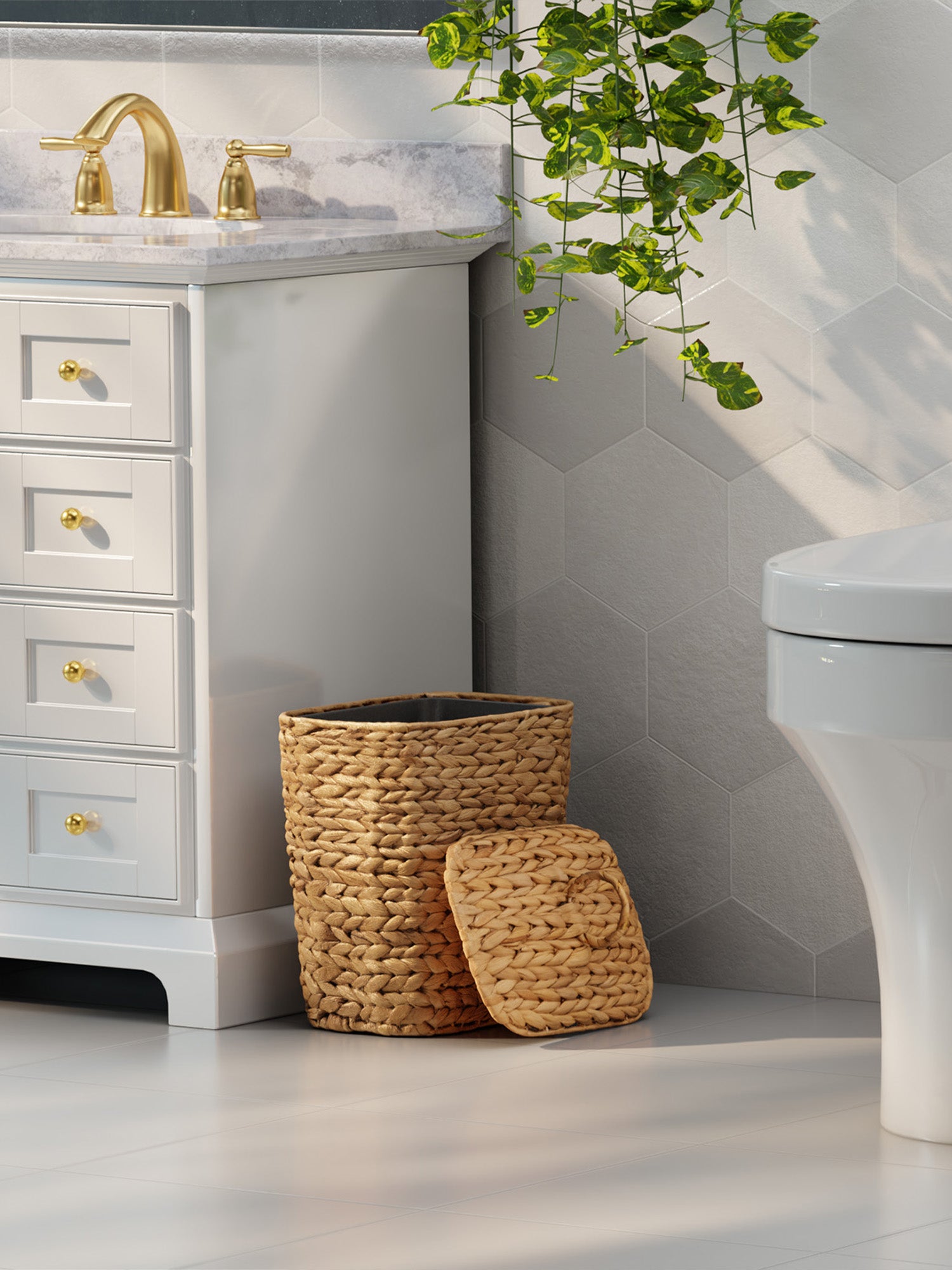 Bathroom with white vanity, gold fixtures, woven basket, and green plant.